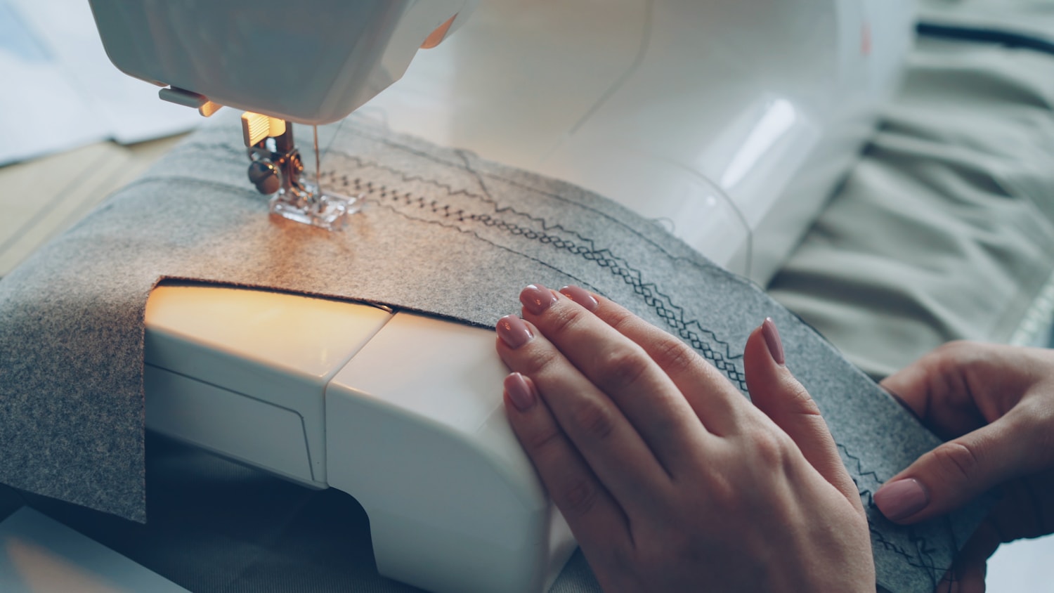 Modern sewing machine creating decorative stitches on fabric